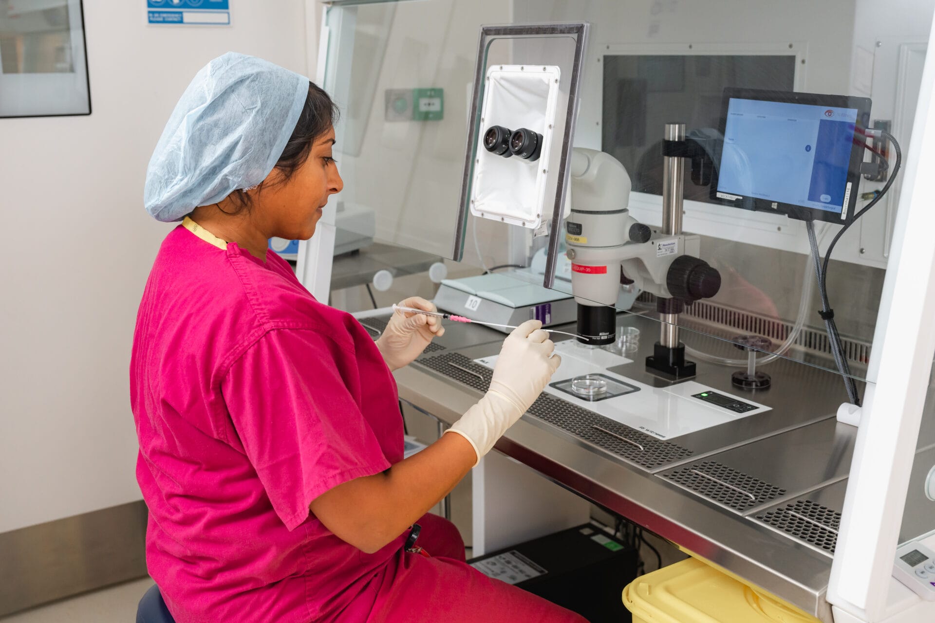 Bourn Hall Wickford-73 Fertility specialist using a microscope.