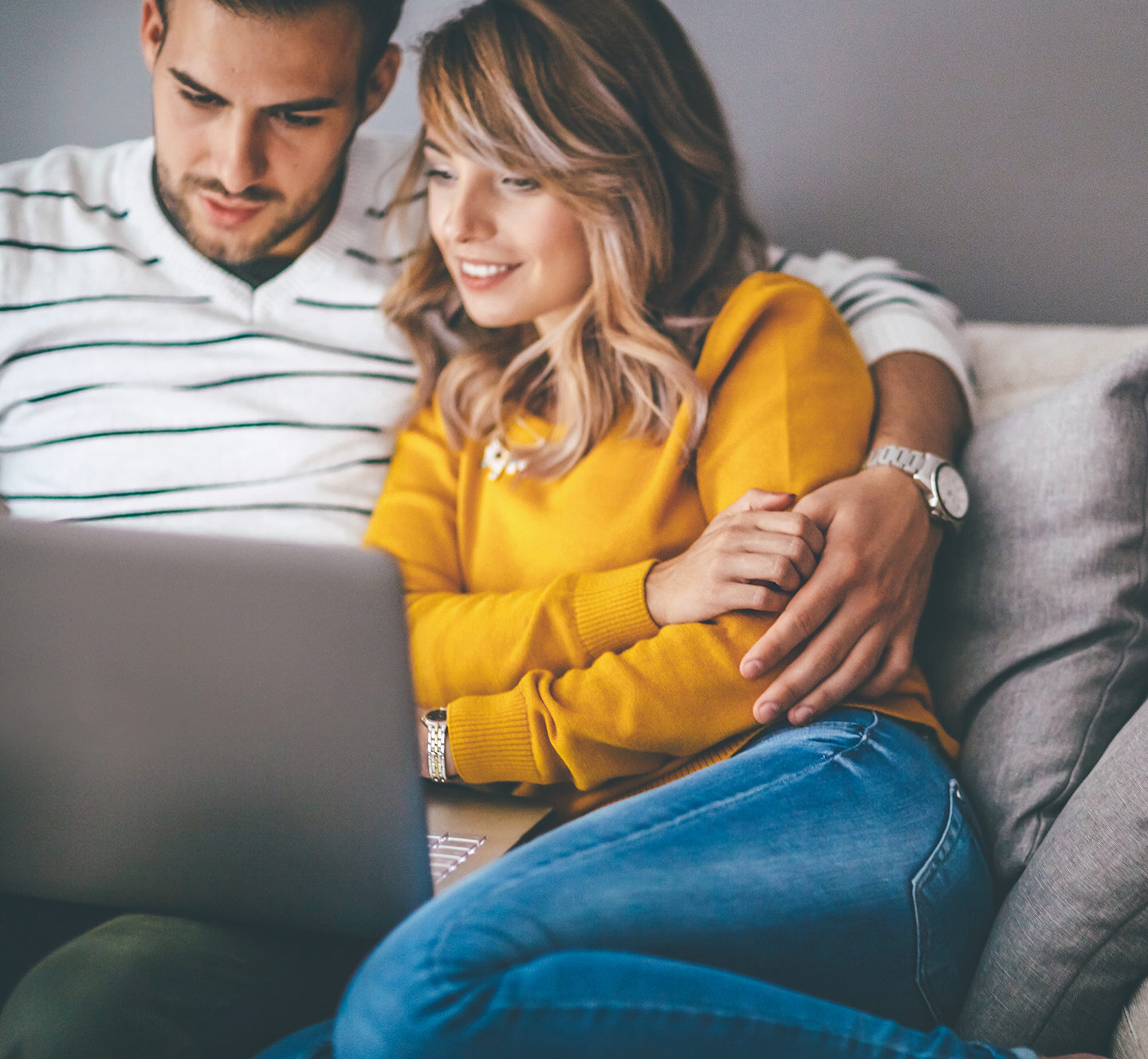 Couple with laptop at home watching movie