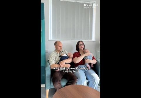 A still from a video of a mother and father holding their babies' and talking about their journey at Bourn Hall.